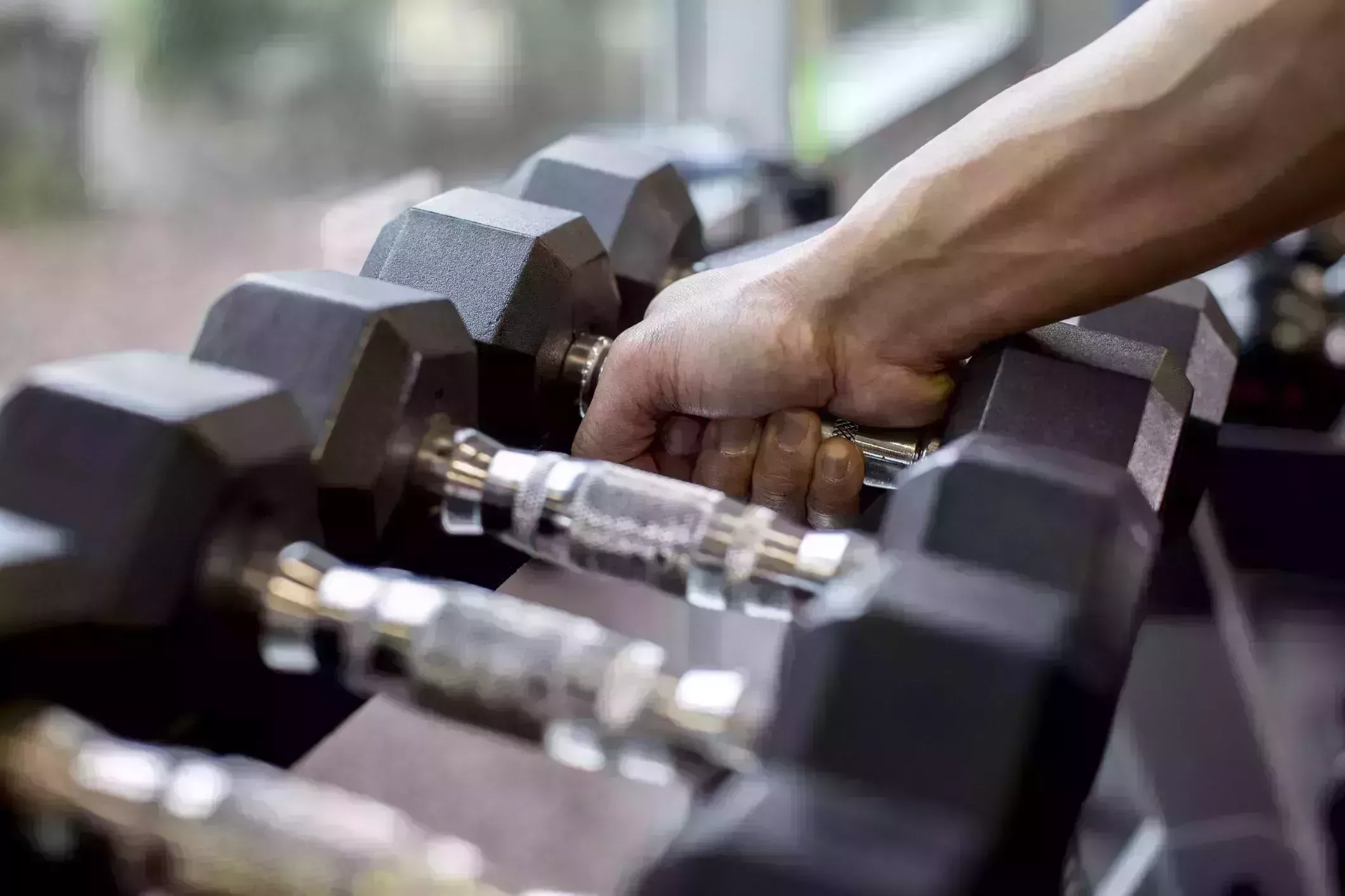 pacific islander man lifting weights in gym