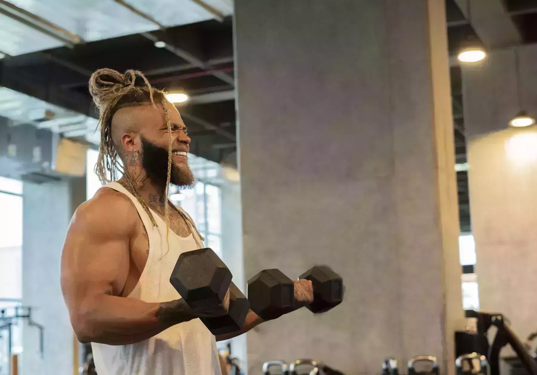 latino man exercises his arms with the help of weights