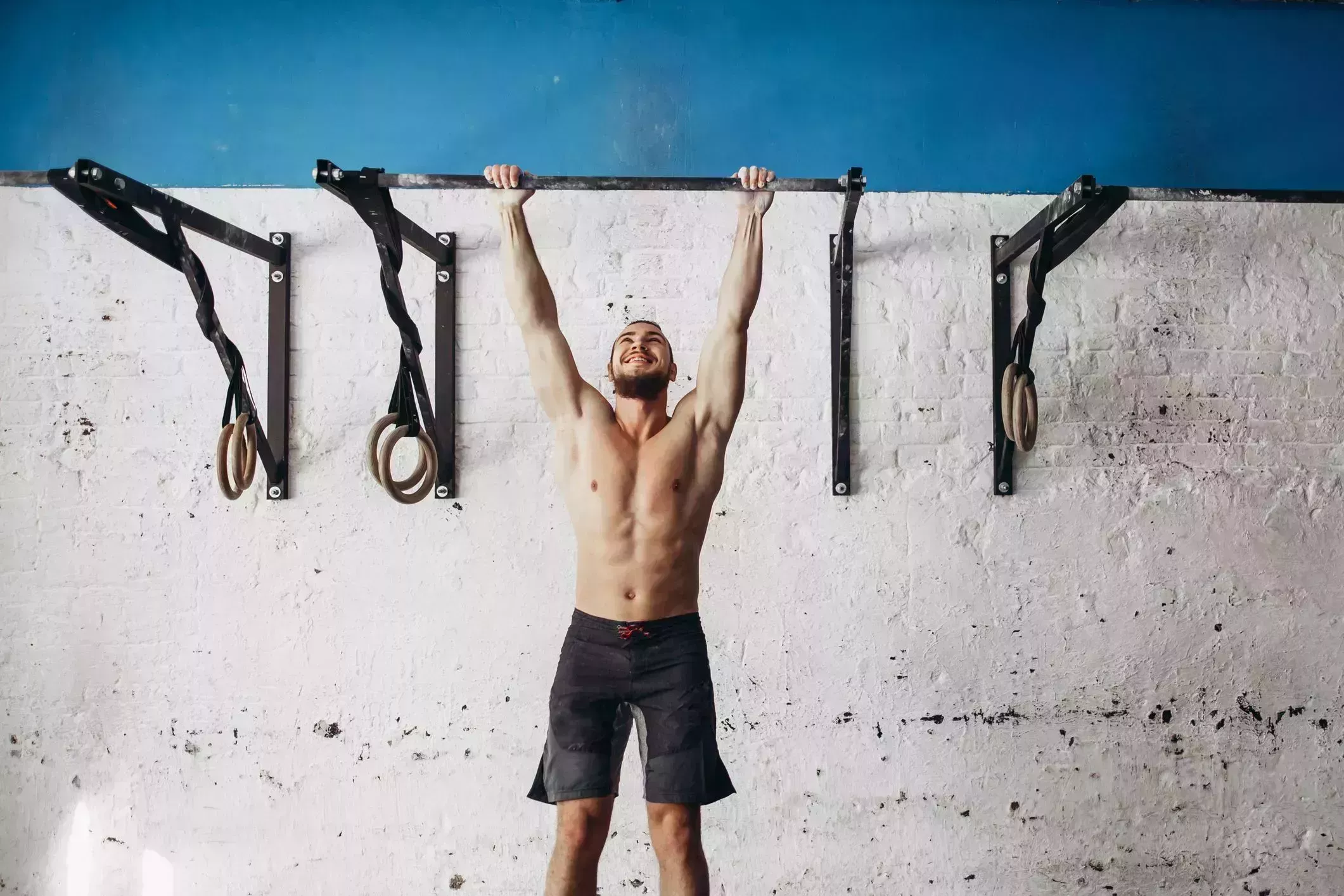 fit toes to bar man pull ups bars workout exercise at gym