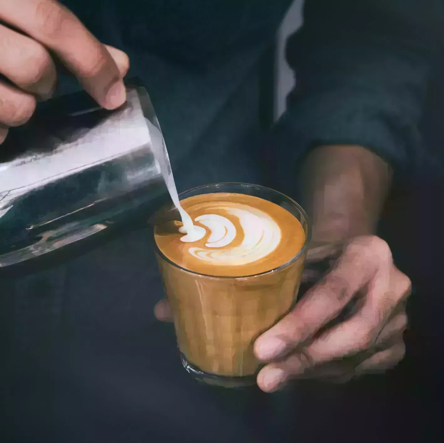 midsection of man pouring milk on coffee