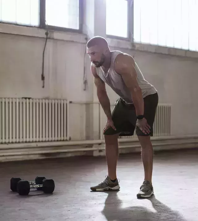 fit caucasian man resting during a workout