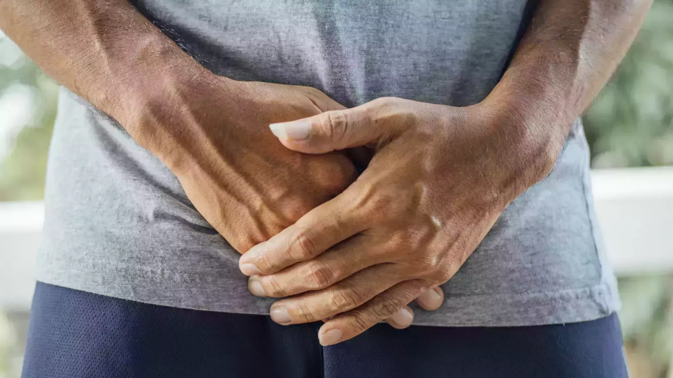 man holding his genitalia concept of pee holding, lack of toilet, prostate cancer, uti or urinary tract infection