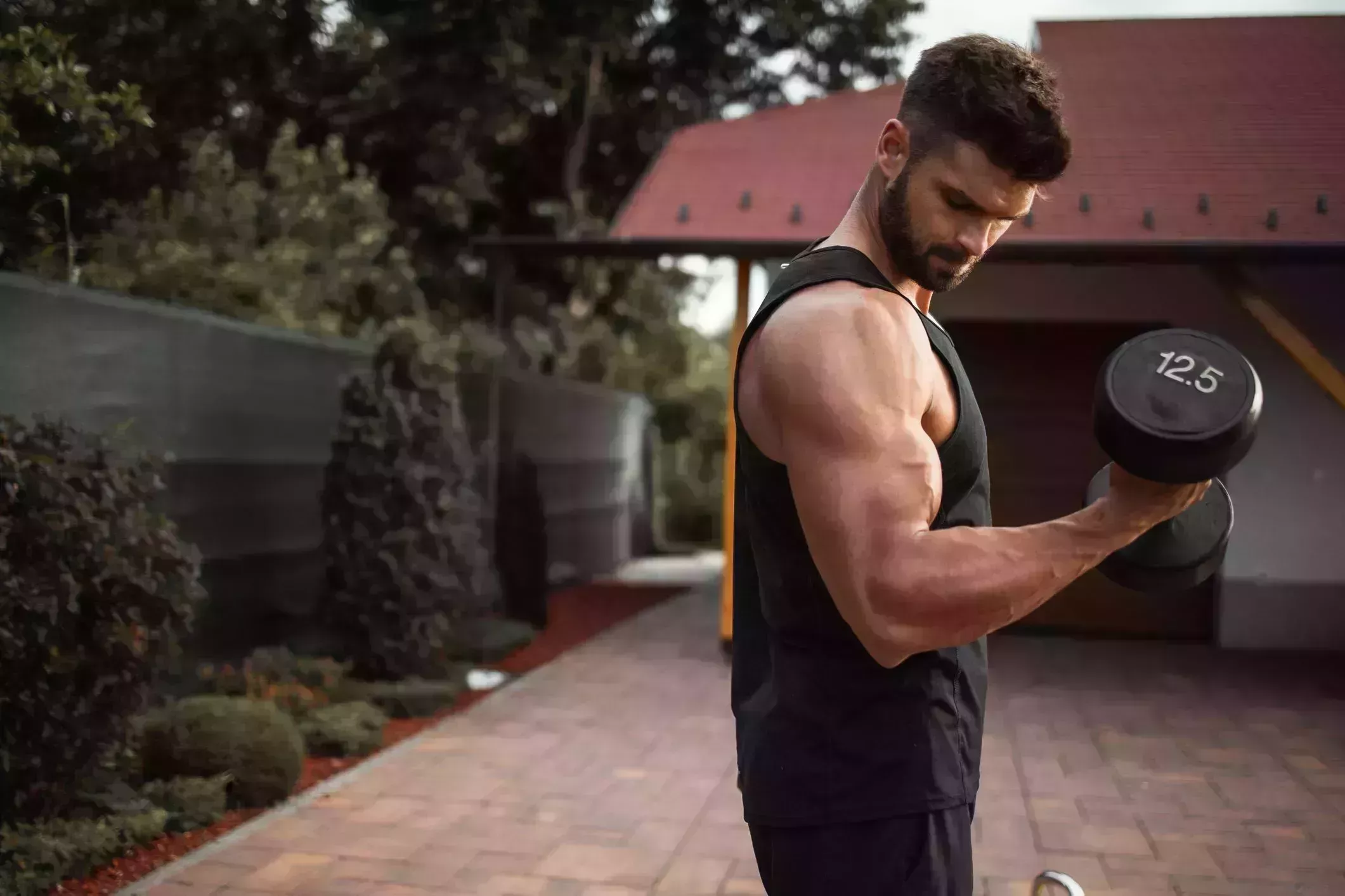 muscular young man exercising in backyard