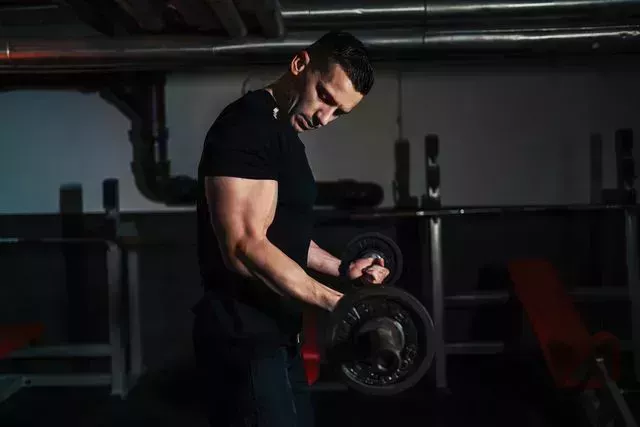 man using the barbell at gym