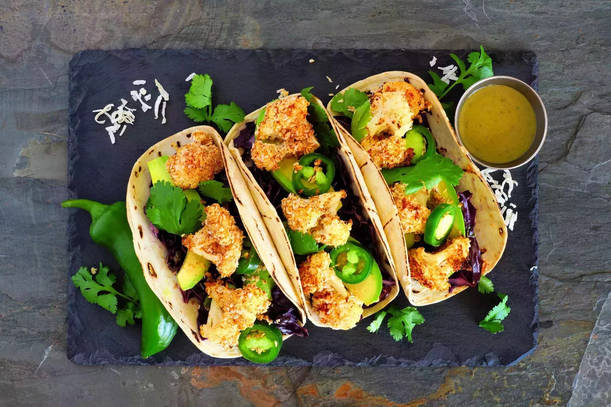 healthy coconut cauliflower tacos, above on dark slate