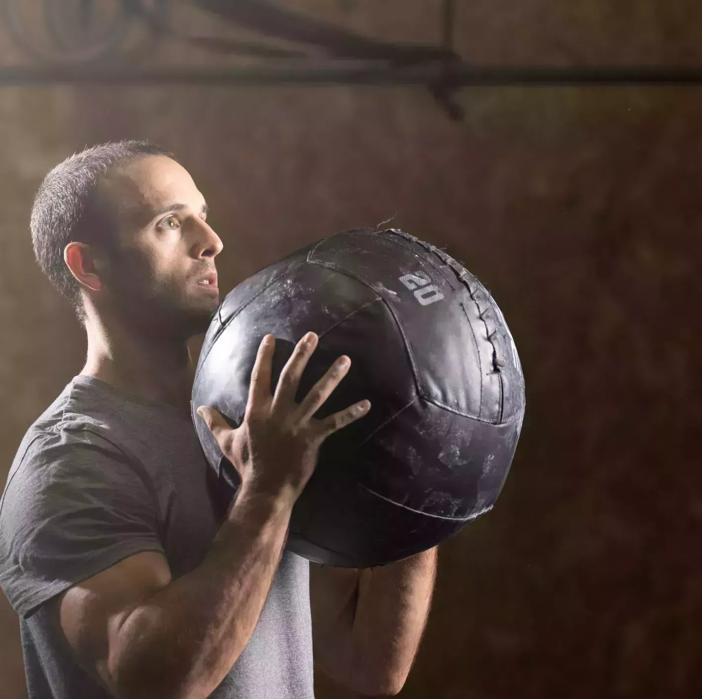 portrait of man using medicine ball