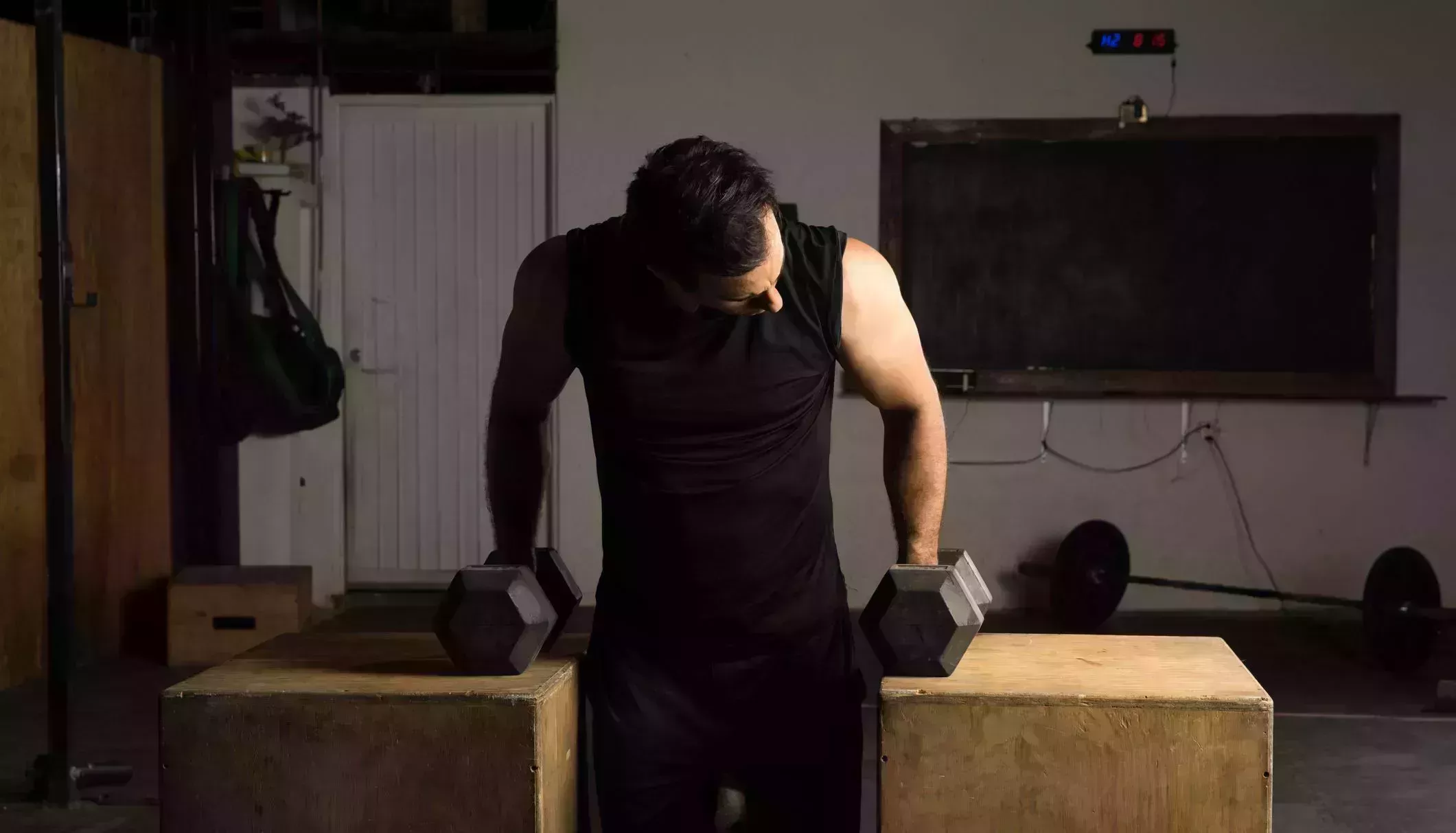 man working on his arms in a gym