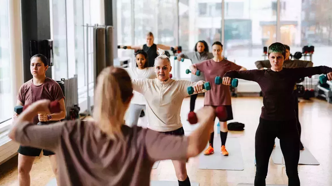 group of people working out in a fitness studio