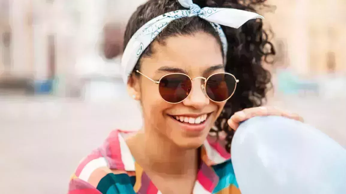 young woman about to inhale helium from a balloon