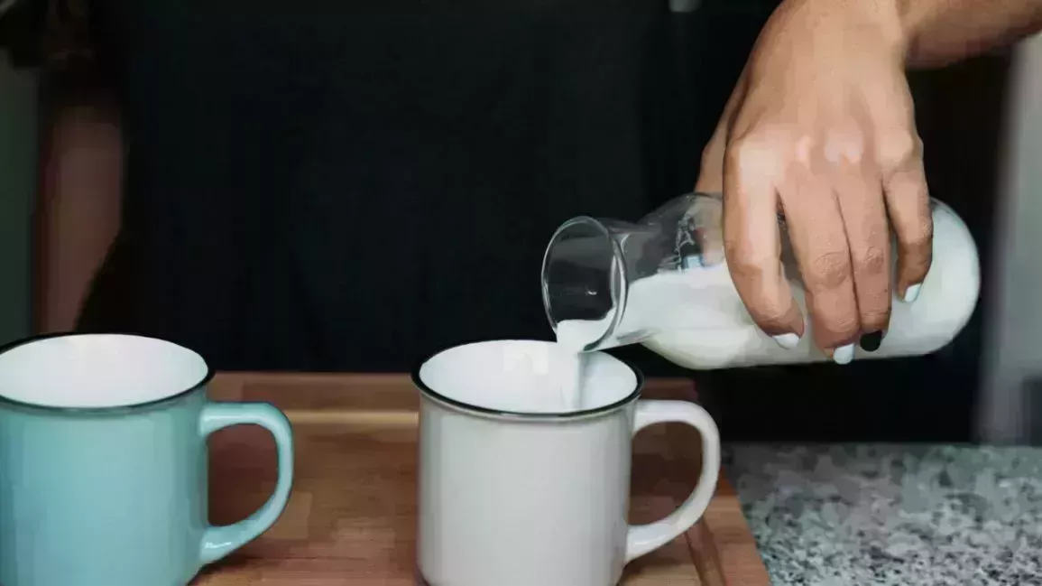 Person pouring milk