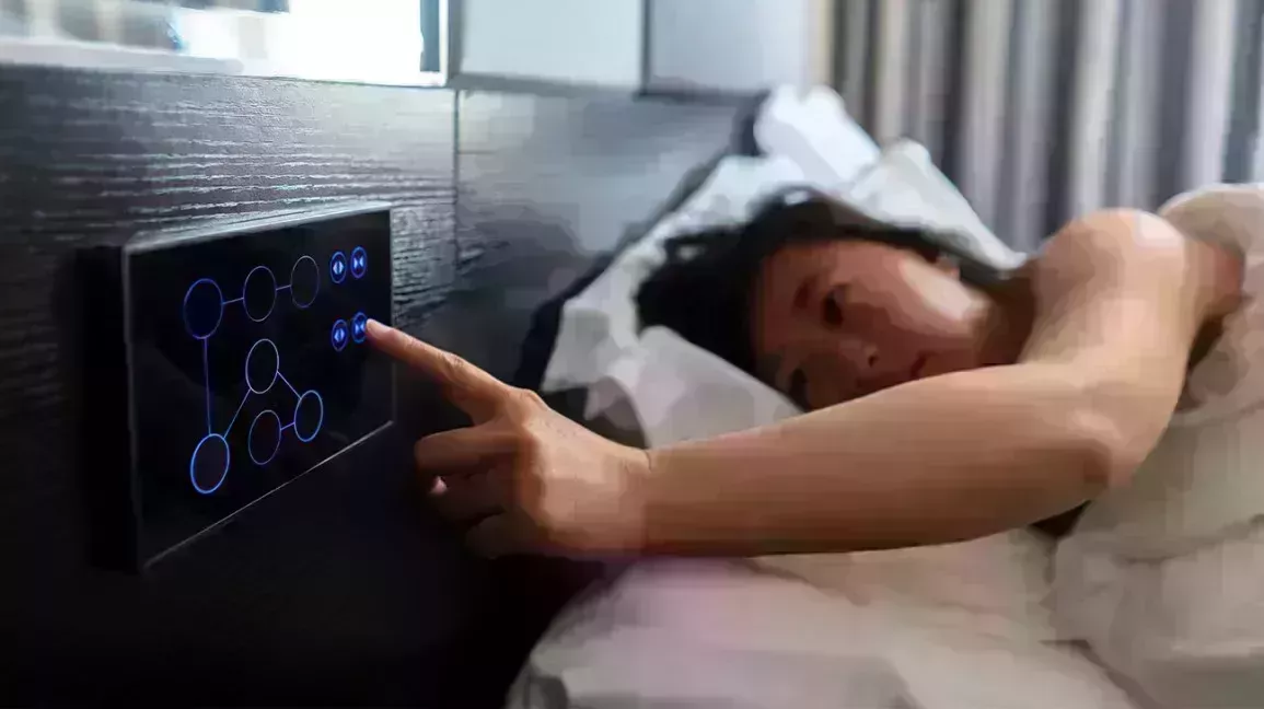person in smart bed adjusts their settings