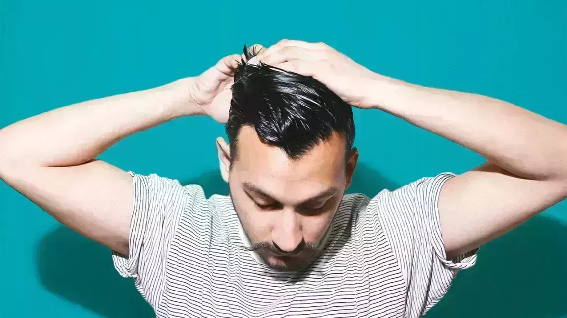 Man touching his hair