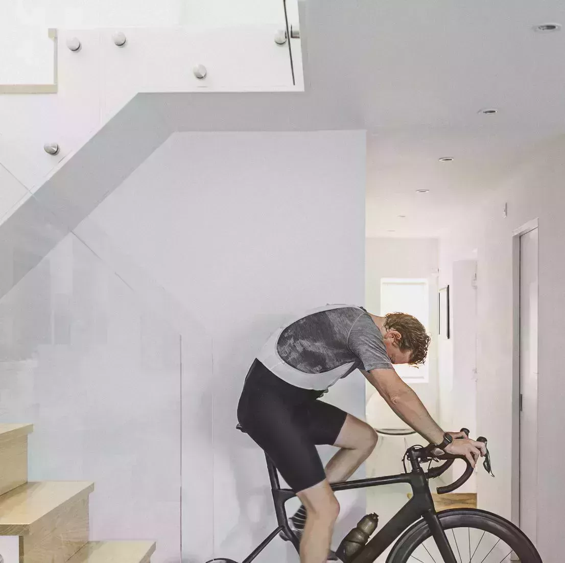 man cycling indoors on turbo trainer best exercise bikes
