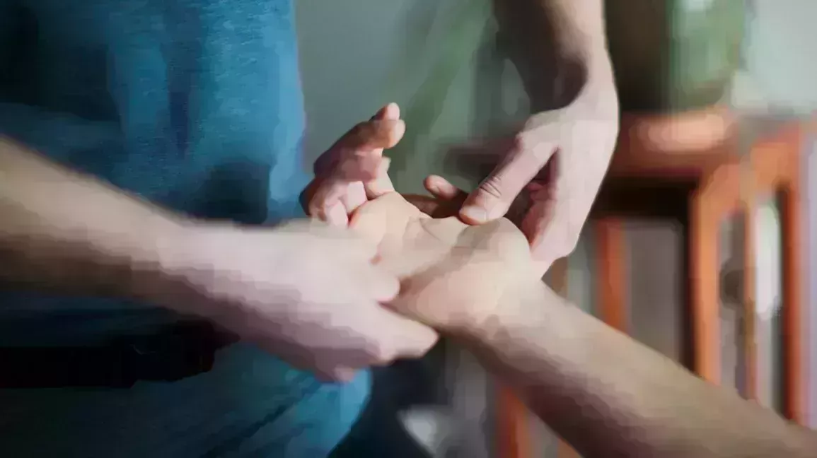person giving a hand massage