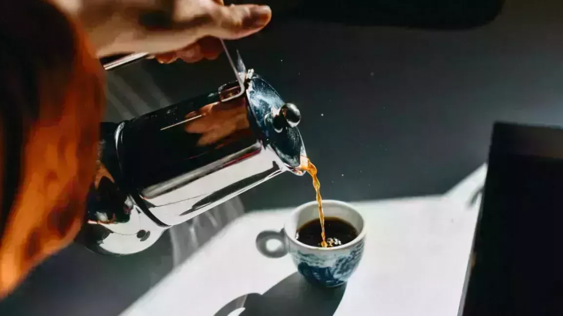 coffee being poured from a carafe into a cup