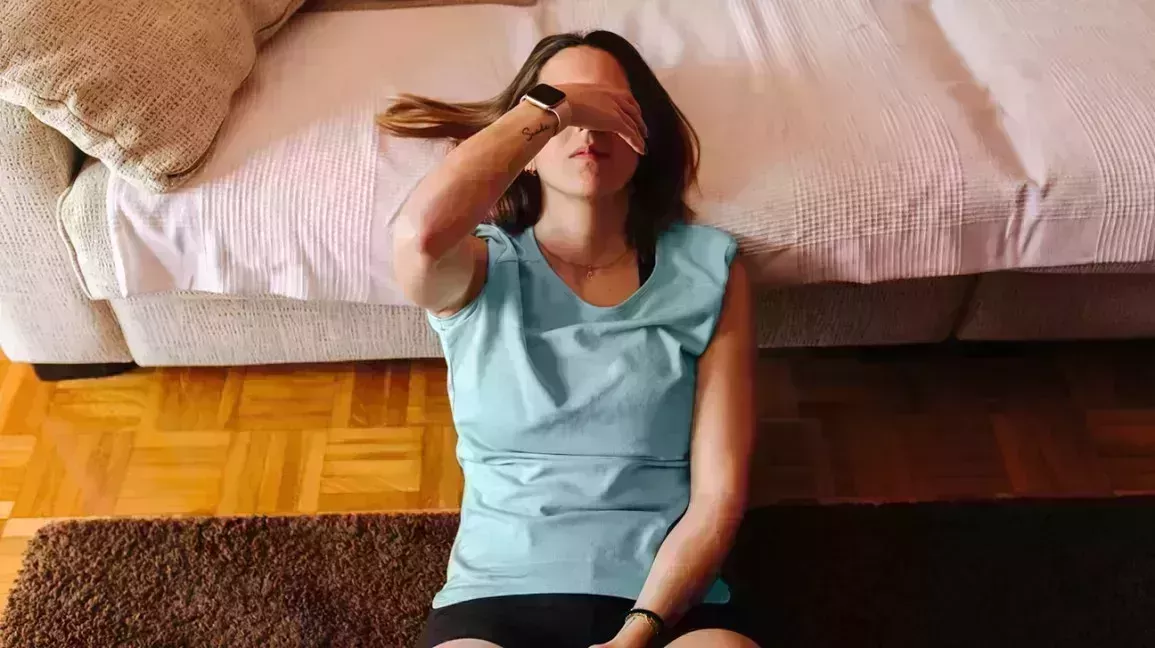 Tired woman covering her eyes