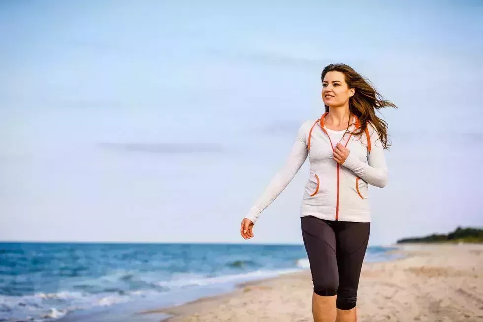 young woman walking on beach