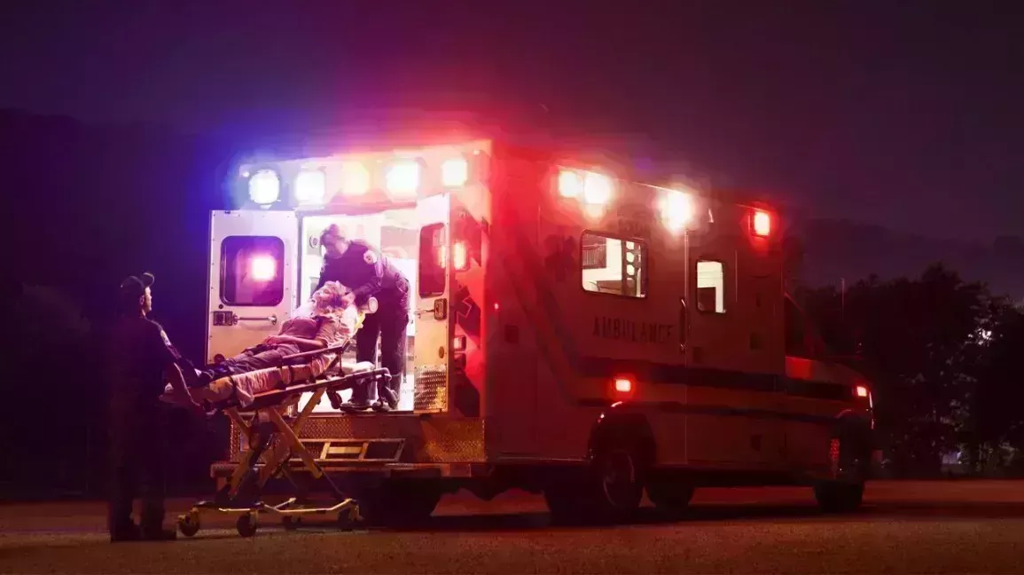person having a heart attack being loaded into an ambulance