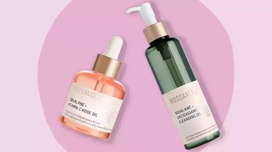 two biossance products against a pink background