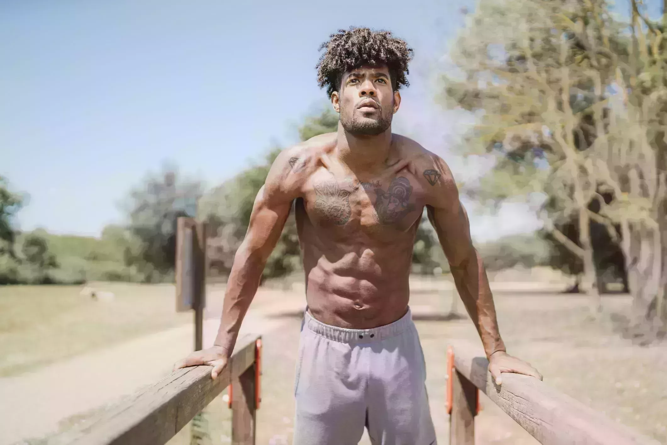 young man during workout on bars in park