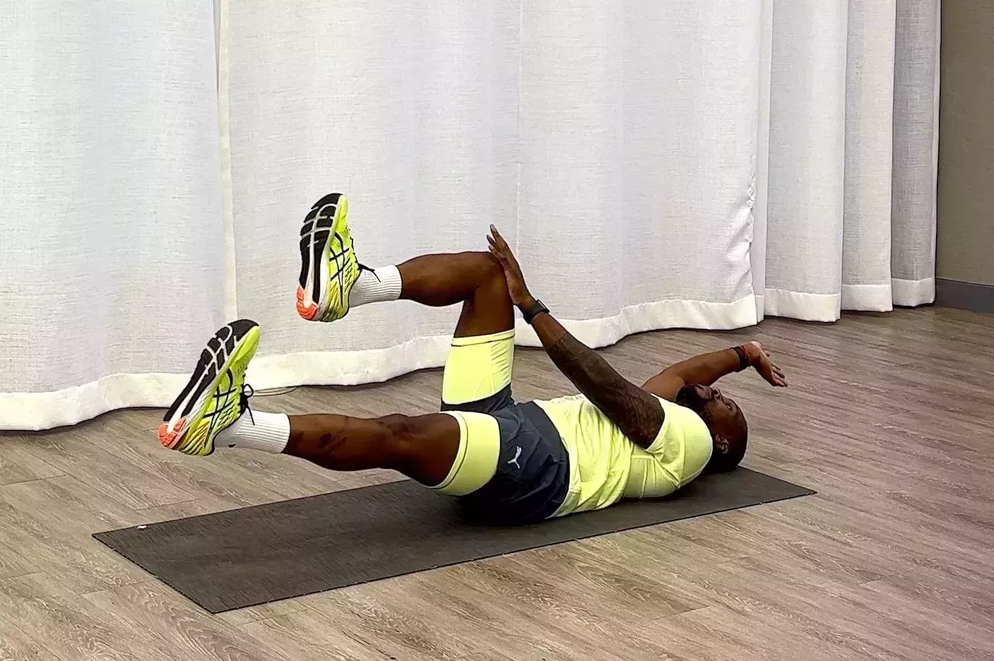 10-Minute Core Workout, Yusuf Jeffers practicing dead bug variation exercise 10minute core workout, yusuf jeffers practicing dead bug variation exercise