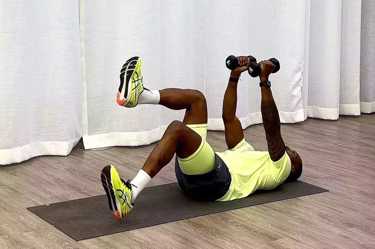 10-Minute core workout, Yusuf Jeffers practicing heel tap with dumbbell hold exercise 10minute core workout, yusuf jeffers practicing heel tap with dumbbell hold exercise