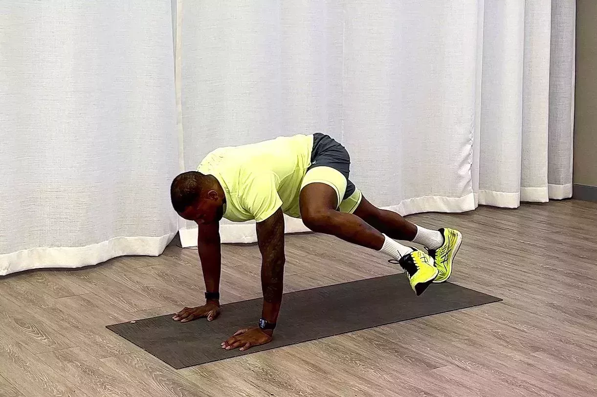 10-minute core workout, Yusuf Jeffers practicing inchworm to plank knee drive exercise 10minute core workout, yusuf jeffers practicing inchworm to plank knee drive exercise