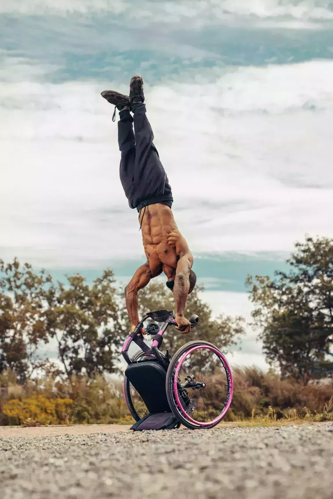 man standing on wheelchair with arms