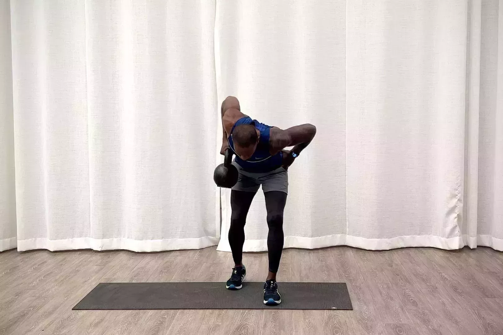 beginner kettlebell workout, jeffers practices the split stance deadlift to bent over row exercise