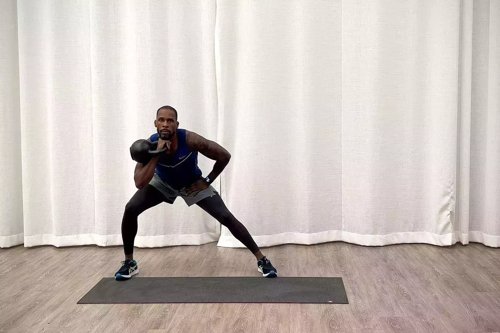 beginner kettlebell workout, jeffers practices the racked forward to lateral lunge