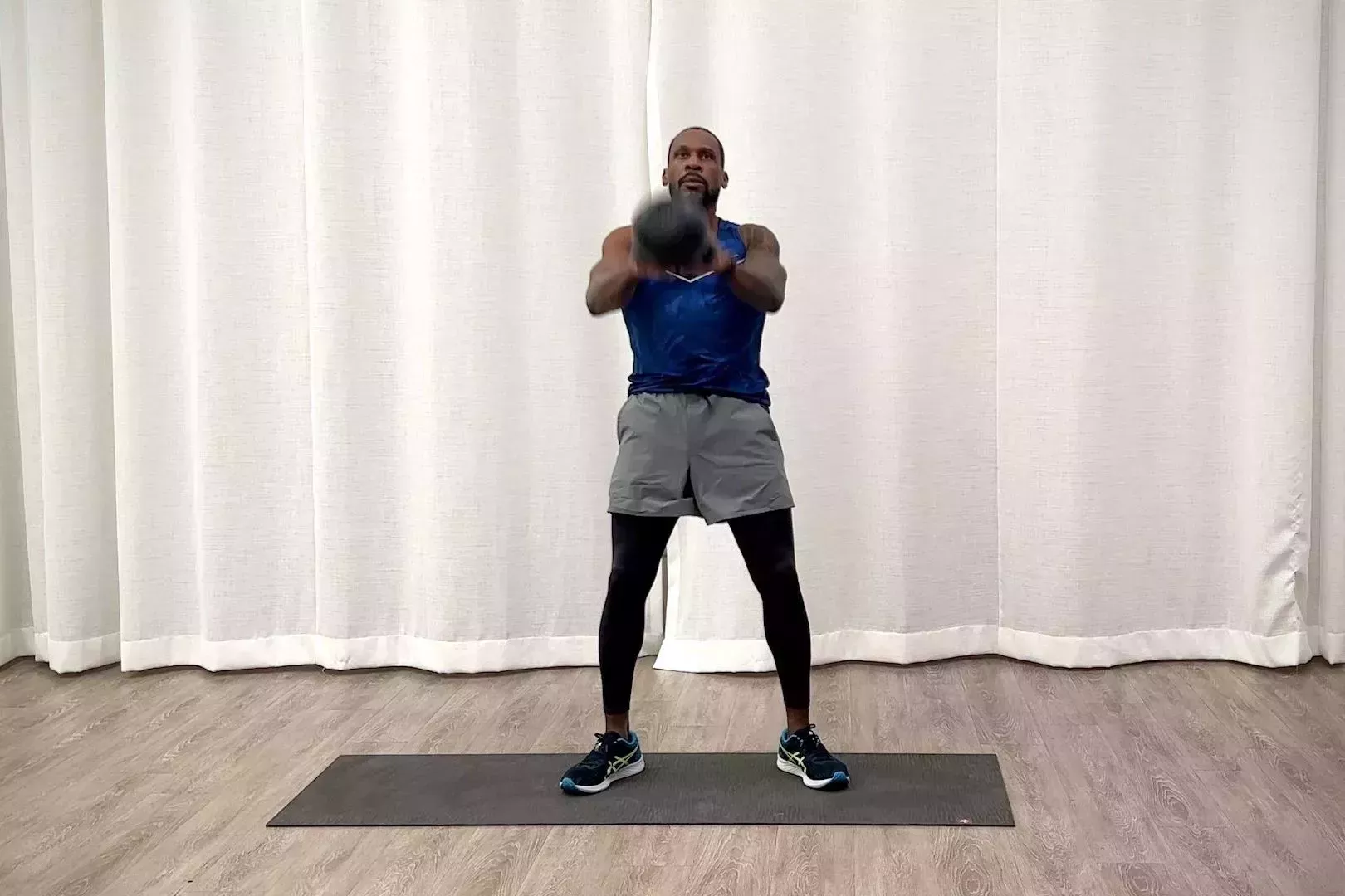 beginner kettlebell workout, jeffers practicing the dead stop swing exercise
