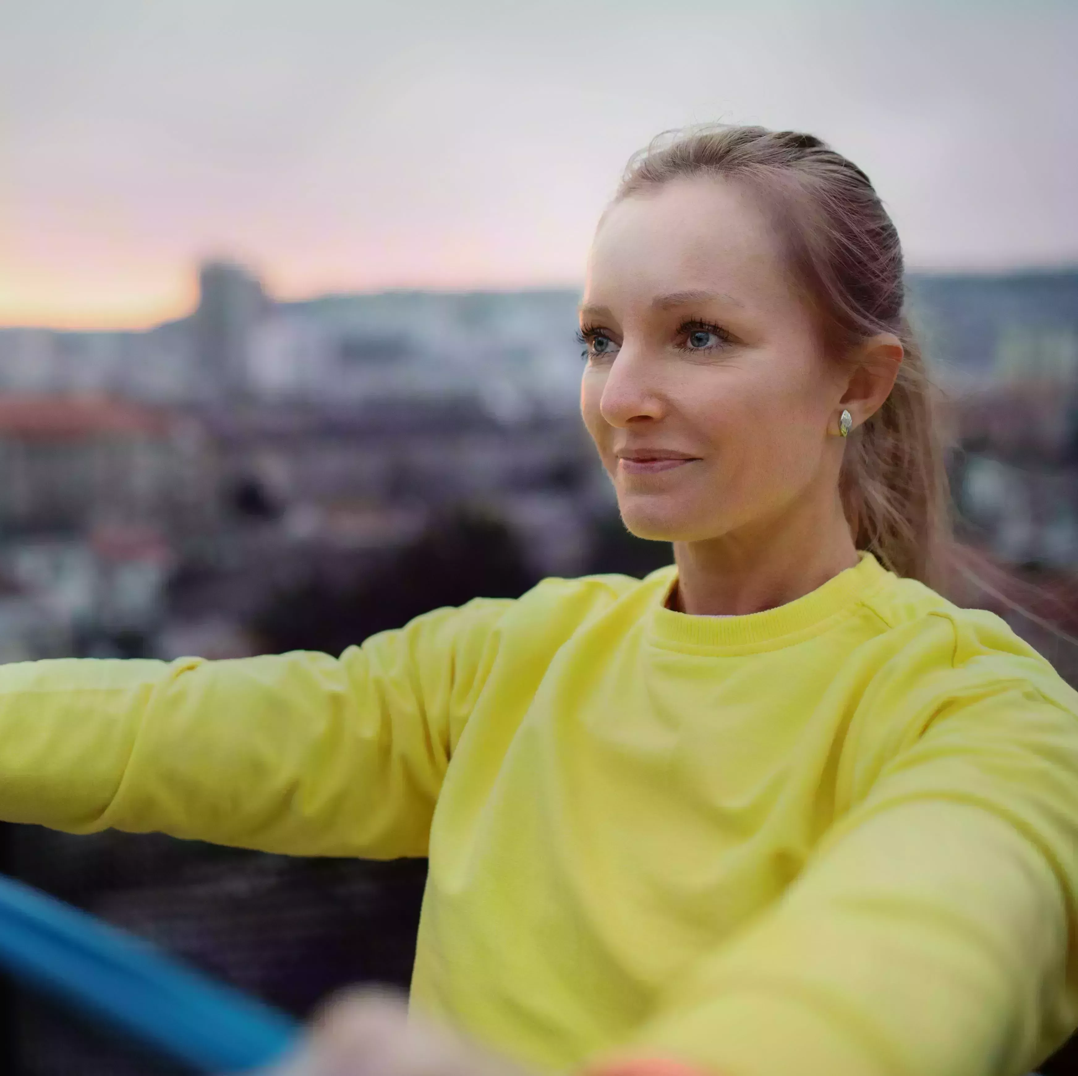 blonde woman exercises with resistance band outside