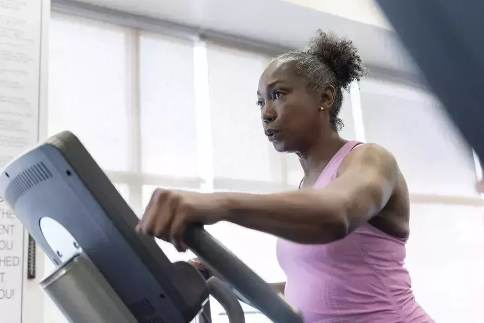 Mature woman exercising on elliptical machine mature woman exercising on elliptical machine