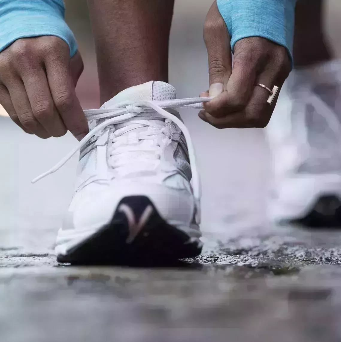 mixed race runner tying shoelaces