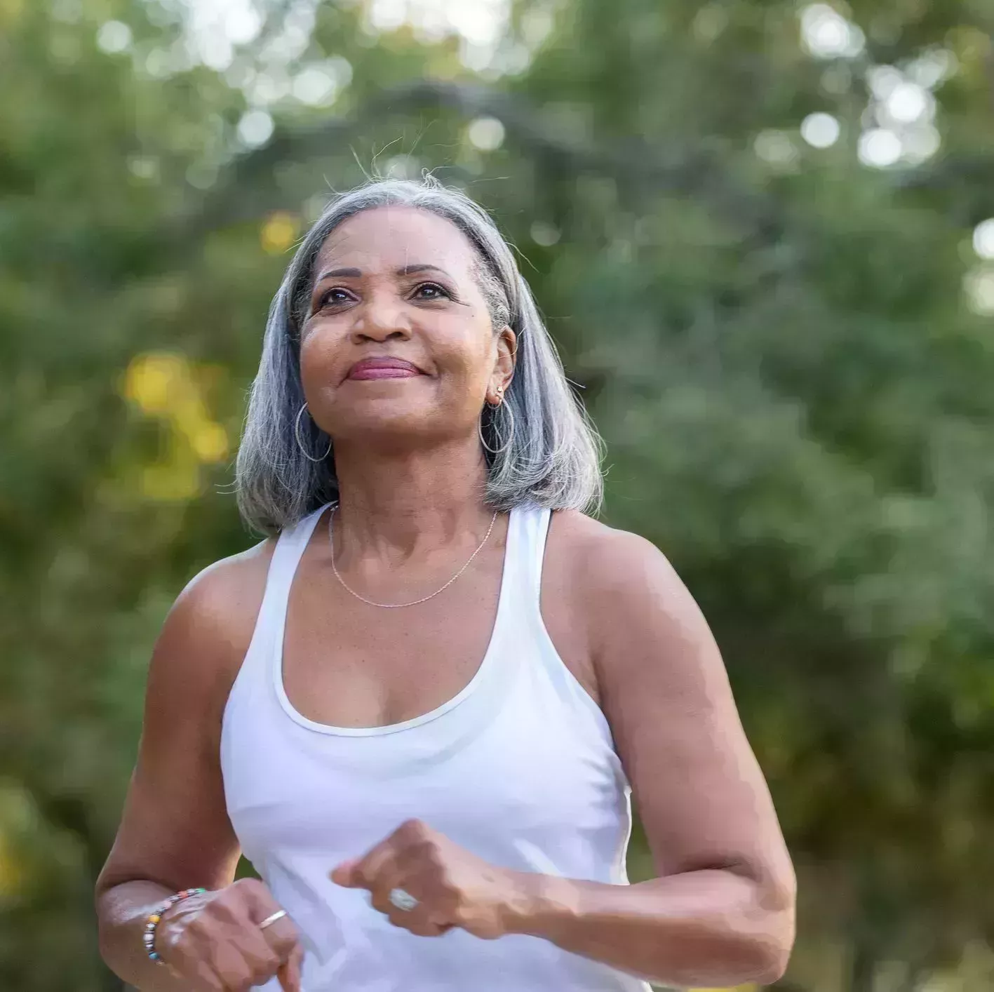 senior woman jogging in public park